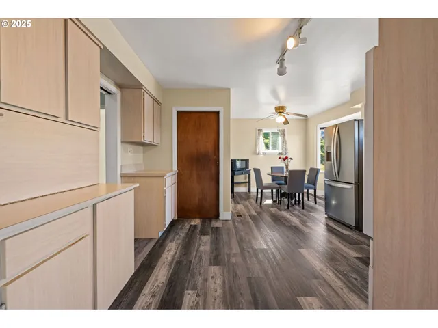 a kitchen with white cabinets and white appliances