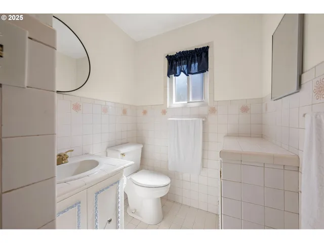 a bed room with a bed and a ceiling fan