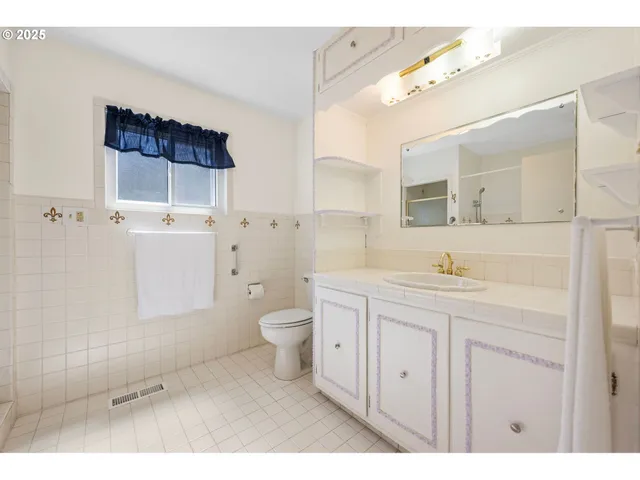 a bathroom with a glass shower door
