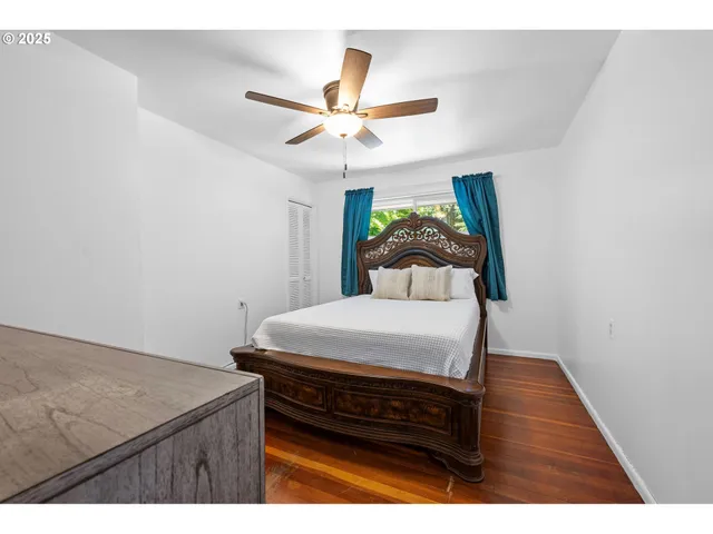 a bedroom with a bed and a large window