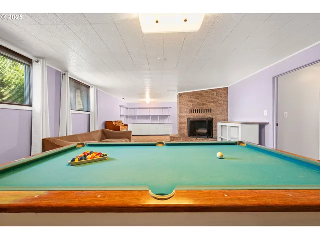 a view of an empty room with a fireplace and a window
