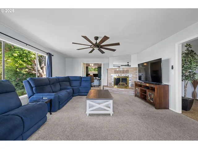 a view of living room with furniture and a fireplace