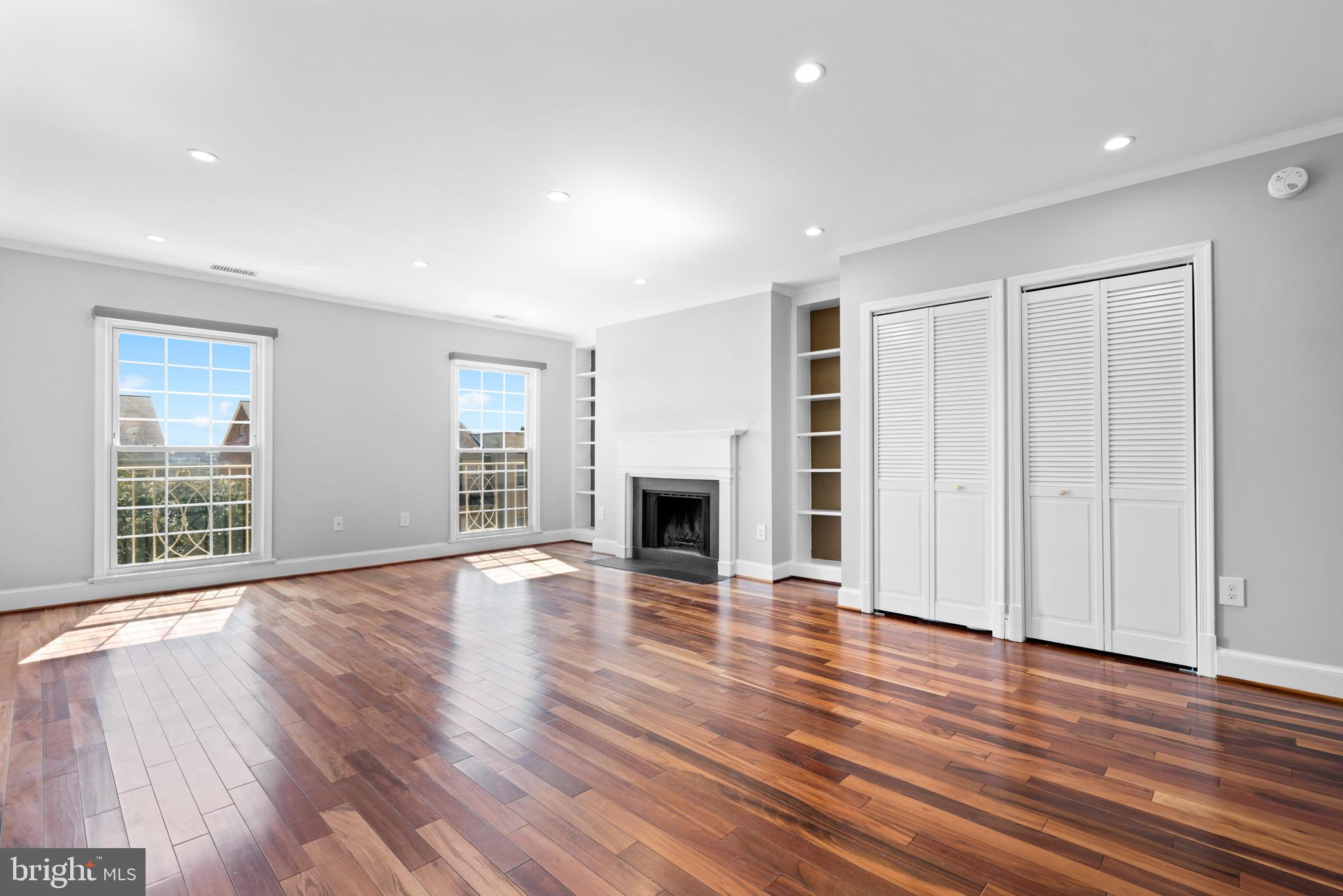 1616 Belmont Street Northwest, Unit A Washington, DC 20009 - Photo 1 of 25 a view of an empty room with wooden floor and a window