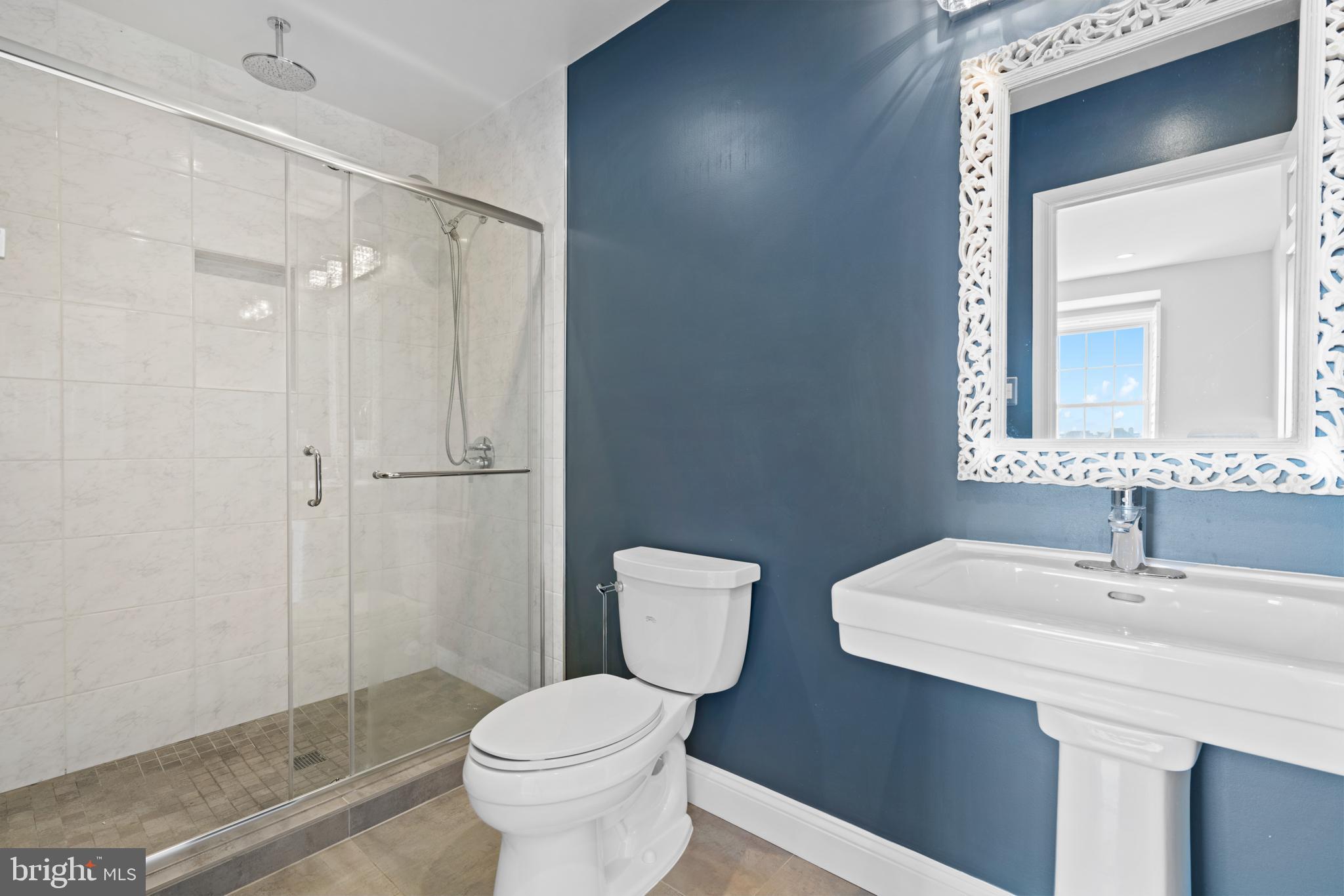 1616 Belmont Street Northwest, Unit A Washington, DC 20009 - Photo 16 of 25 a bathroom with a toilet a sink and mirror