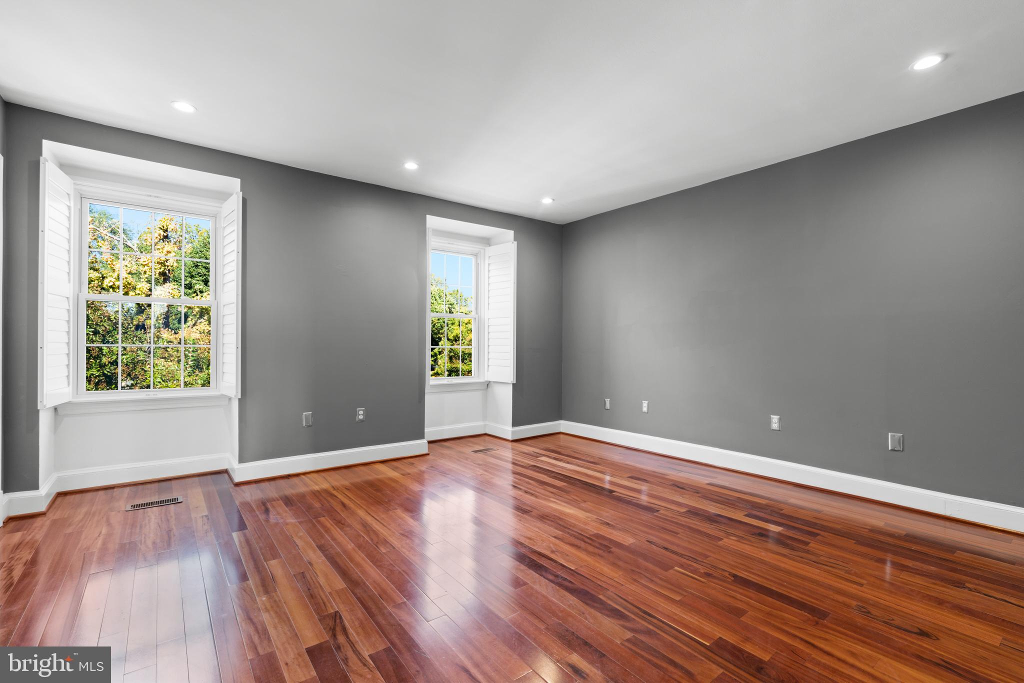 1616 Belmont Street Northwest, Unit A Washington, DC 20009 - Photo 18 of 25 a view of an empty room with wooden floor and a window