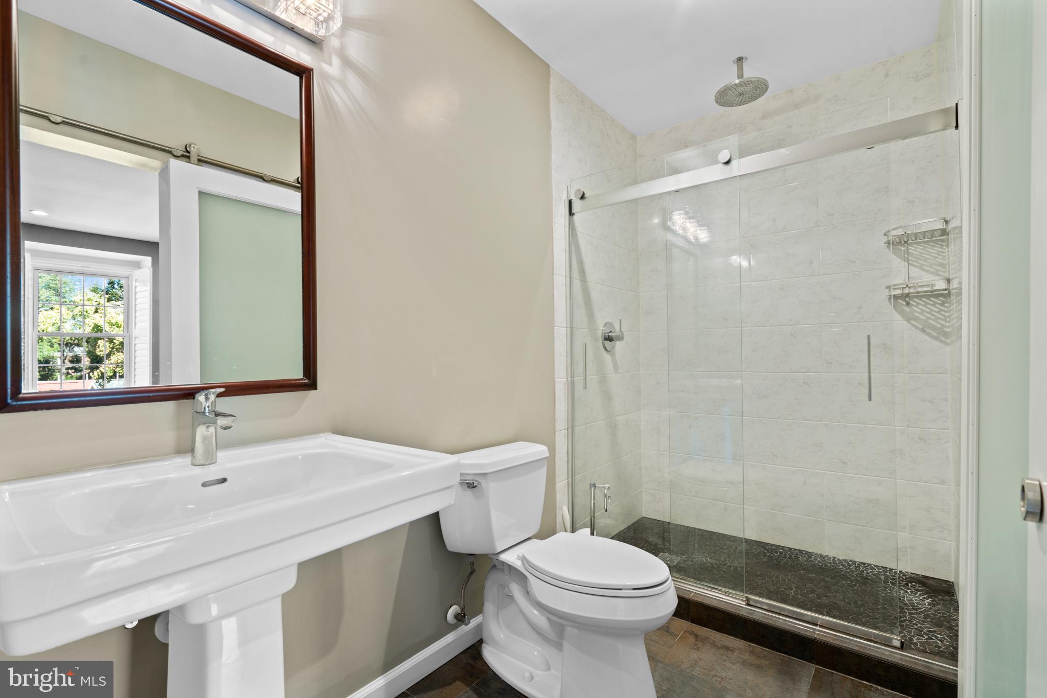 1616 Belmont Street Northwest, Unit A Washington, DC 20009 - Photo 20 of 25 a bathroom with a sink toilet and shower