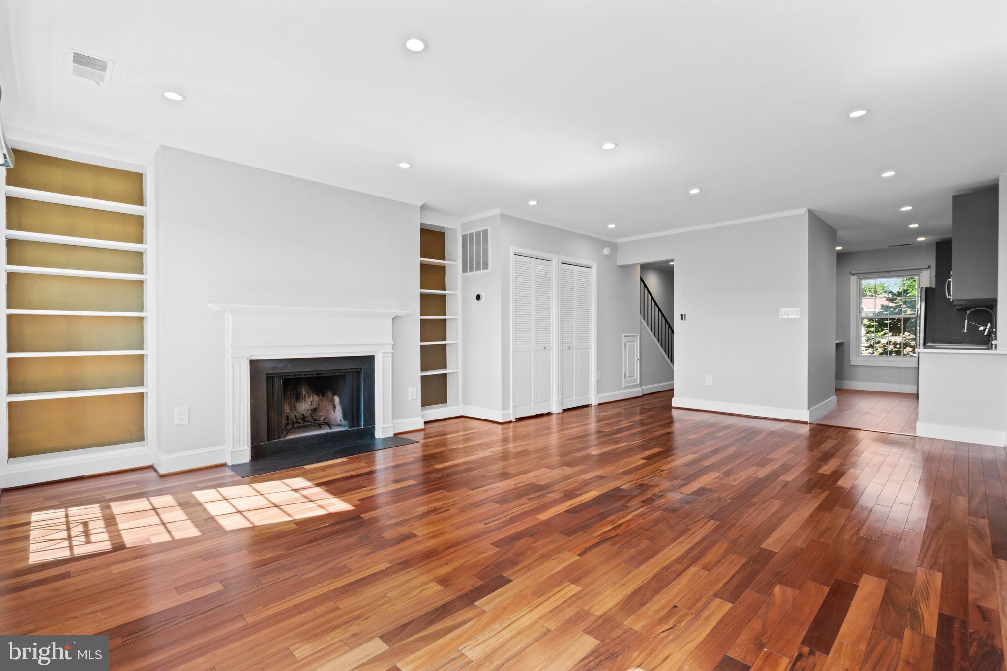 1616 Belmont Street Northwest, Unit A Washington, DC 20009 - Photo 4 of 25 a view of empty room with wooden floor and fireplace