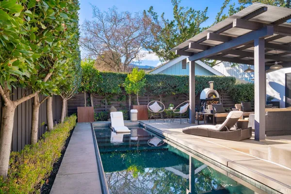 a view of a patio with a table chairs and a backyard