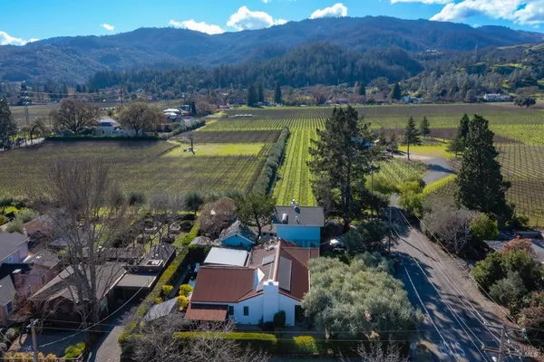 an aerial view of a house with garden space and lake view