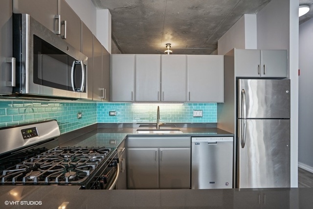 235 West Van Buren Street, Unit 1505 Chicago, IL 60607 - Photo 12 of 28 a kitchen with stainless steel appliances granite countertop a refrigerator and a stove top oven