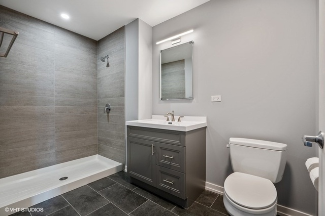 235 West Van Buren Street, Unit 1505 Chicago, IL 60607 - Photo 21 of 28 a bathroom with a sink a toilet and shower