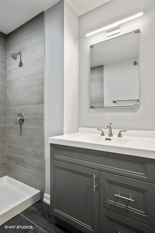 235 West Van Buren Street, Unit 1505 Chicago, IL 60607 - Photo 22 of 28 a bathroom with a sink and a mirror