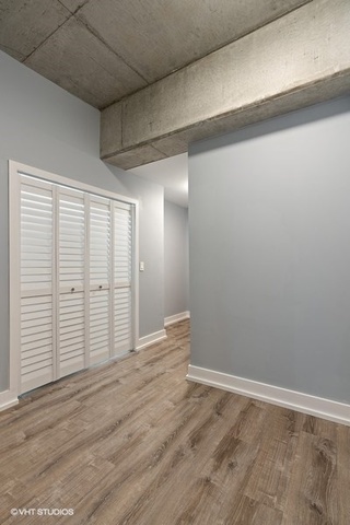 235 West Van Buren Street, Unit 1505 Chicago, IL 60607 - Photo 7 of 28 a view of an empty room with wooden floor