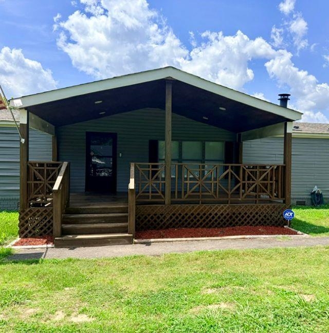 229 Coats Road Brighton, TN 38011 - Photo 11 of 14 Covered front porch with wood-finish decking and decorative railings
