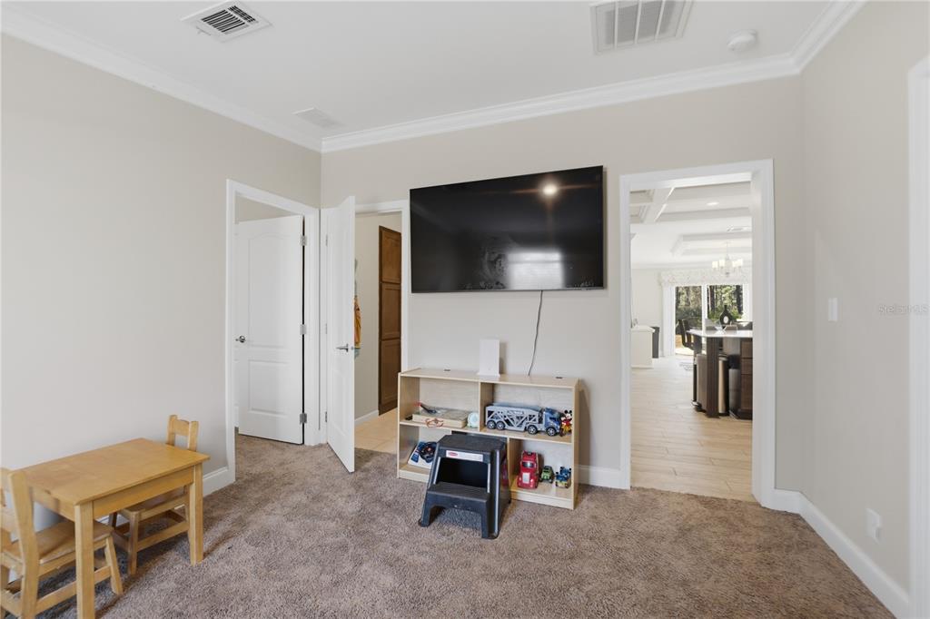 6844 Chad Jason Road St. Cloud, FL 34773 - Photo 23 of 59 a living room with furniture and a flat screen tv