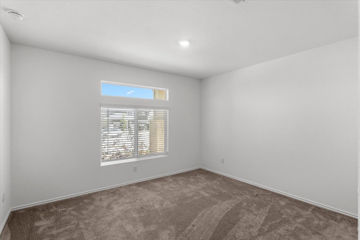 167 Jeffers Kyle, TX 78640 - Photo 11 of 40 Spare room with dark carpet and a smoke detector