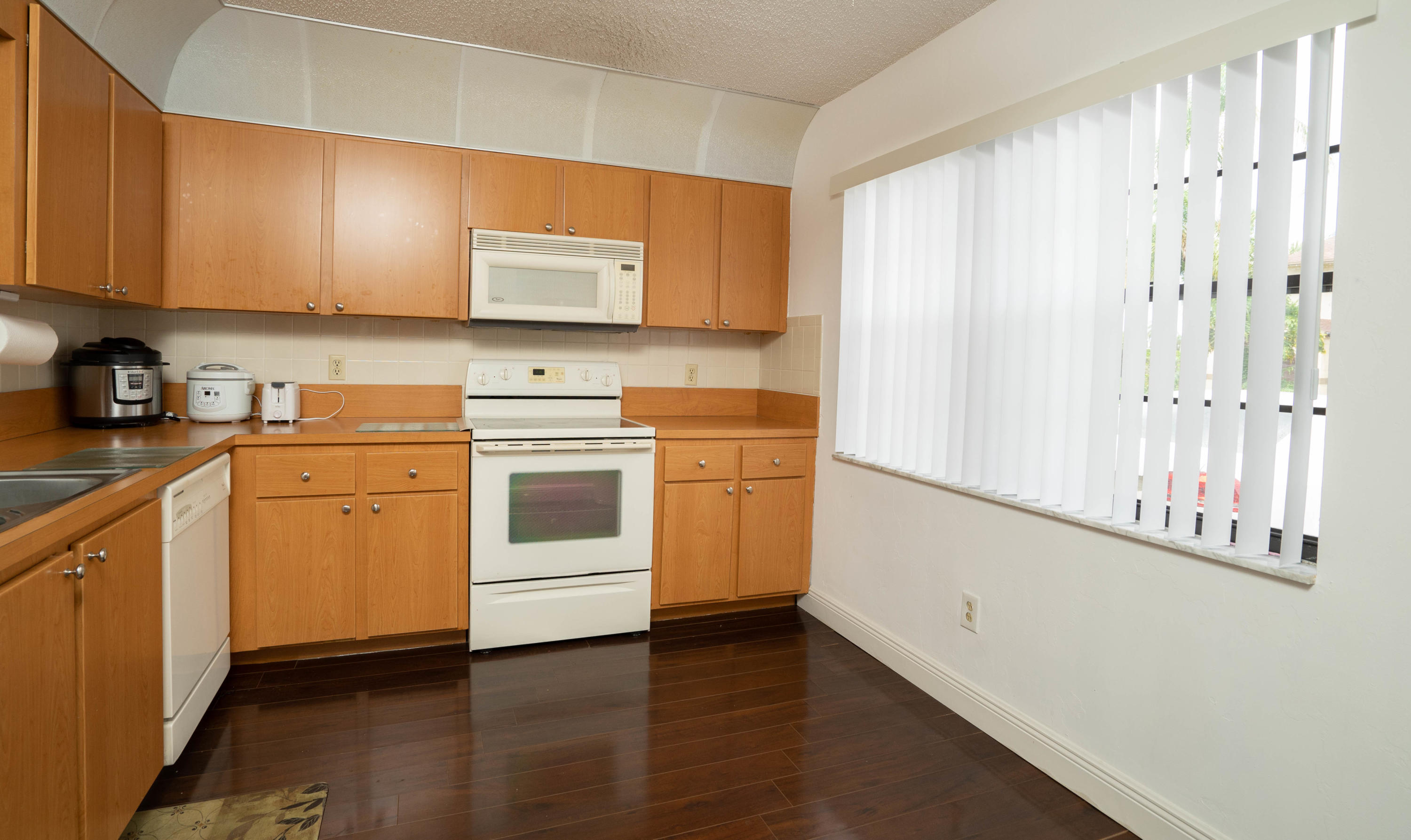 8930 Southwest 19th Street, Unit G Boca Raton, FL 33433 - Photo 13 of 18 a view of a kitchen with stove and cabinets