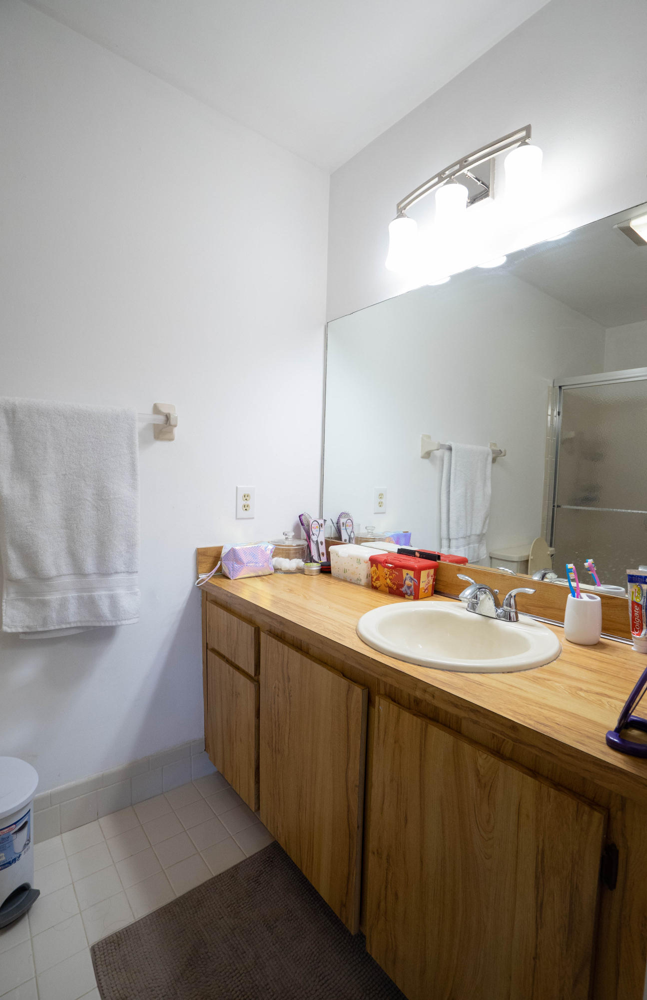 8930 Southwest 19th Street, Unit G Boca Raton, FL 33433 - Photo 8 of 18 a bathroom with a double vanity sink and a mirror