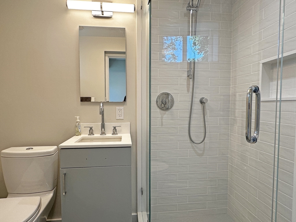 6 Brownson Terrace Boston, MA 02130 - Photo 32 of 38 a bathroom with a sink a toilet and shower