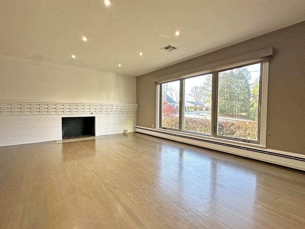 6 Brownson Terrace Boston, MA 02130 - Photo 4 of 38 a view of empty room with wooden floor and fireplace