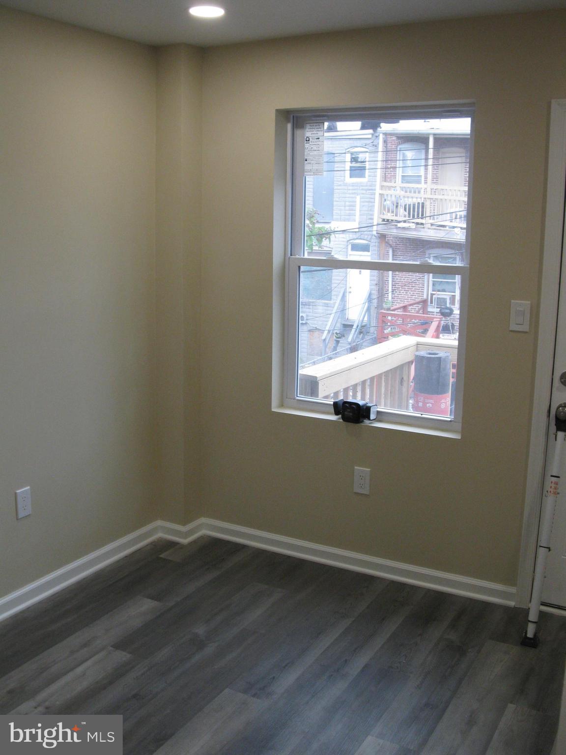 708 North Glover Street Baltimore, MD 21205 - Photo 15 of 38 a view of a small space with wooden floor and a window