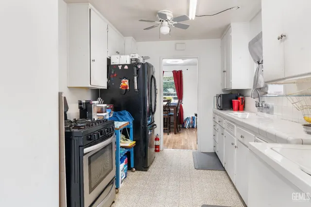 a kitchen with refrigerator and cabinets