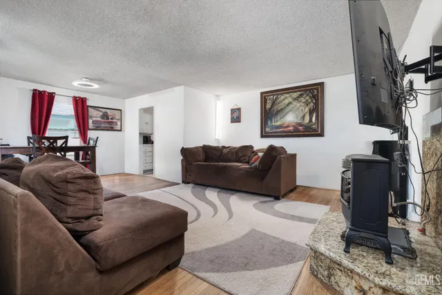 a living room with furniture a couch and a flat screen tv