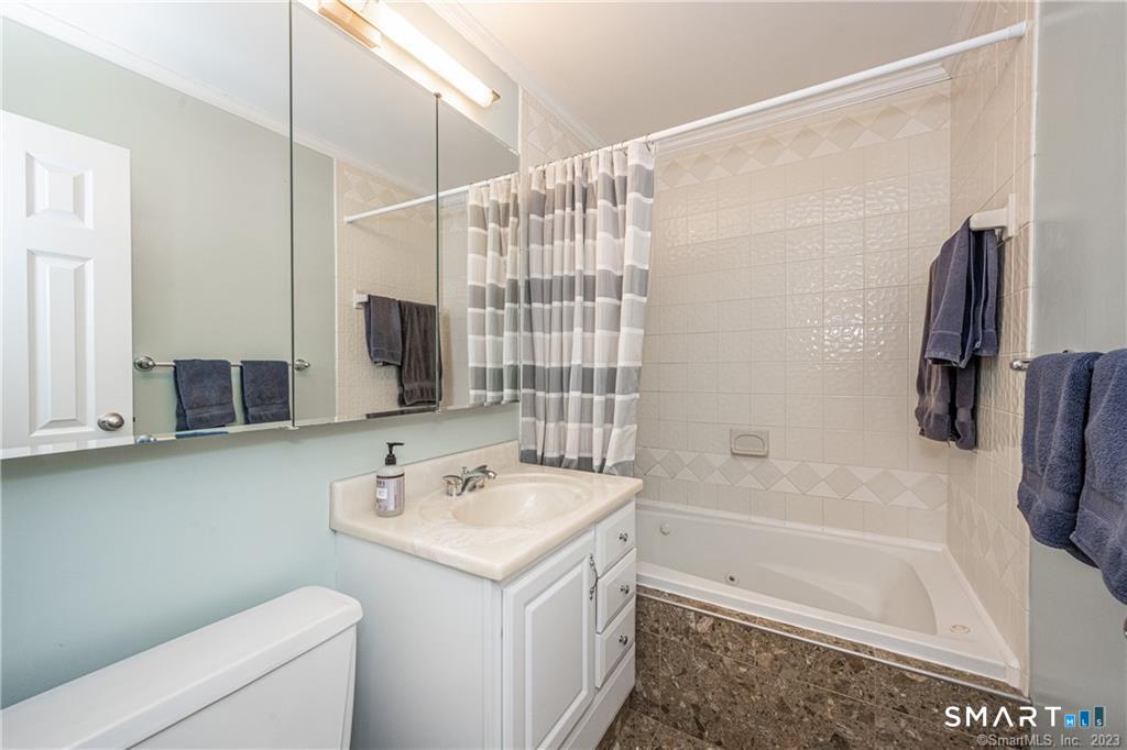 50 Glenbrook Road, Unit 6E Stamford, CT 06902 - Photo 15 of 18 a bathroom with a sink a toilet and shower