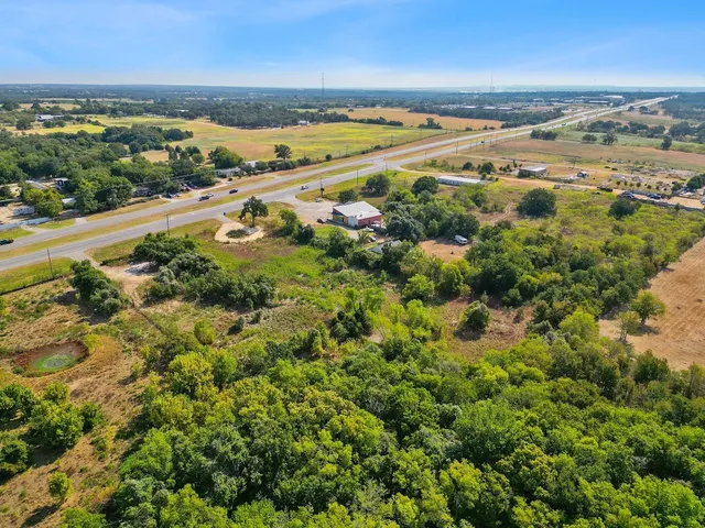 an aerial view of beach and residential houses with outdoor space and ocean view