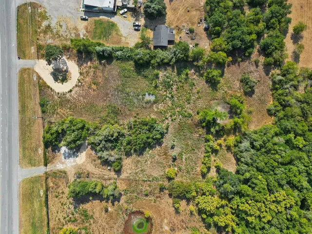 an aerial view of a house with a yard