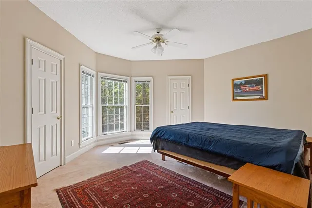 a bedroom with a bed and a dresser with the outer view