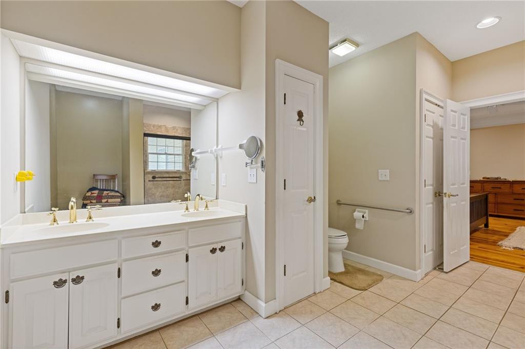 3740 Woodlane Road Gainesville, GA 30506 - Photo 21 of 74 a spacious bathroom with a double vanity sink a mirror and a shower