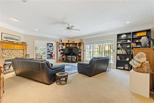 a living room with couches and kitchen view with wooden floor