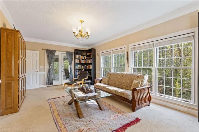 a view of a dining room with furniture a chandelier and wooden floor