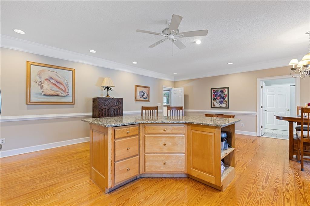 3740 Woodlane Road Gainesville, GA 30506 - Photo 33 of 74 a kitchen with stainless steel appliances granite countertop a stove cabinets and wooden floor