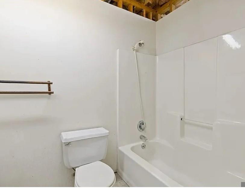 3740 Woodlane Road Gainesville, GA 30506 - Photo 40 of 70 a white toilet sitting next to a bath tub