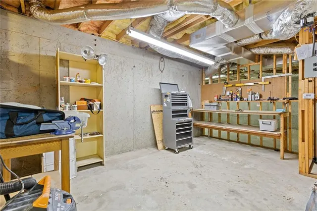 a view of backyard with wooden fence and large trees