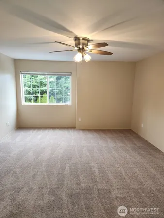 a bathroom with a granite countertop sink toilet and mirror