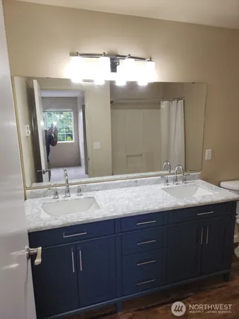 a view of a room with wooden floor and cabinet