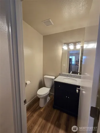 a spacious bathroom with a toilet a sink and mirror