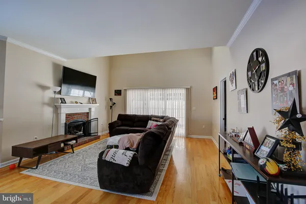 a living room with furniture a fireplace and a window