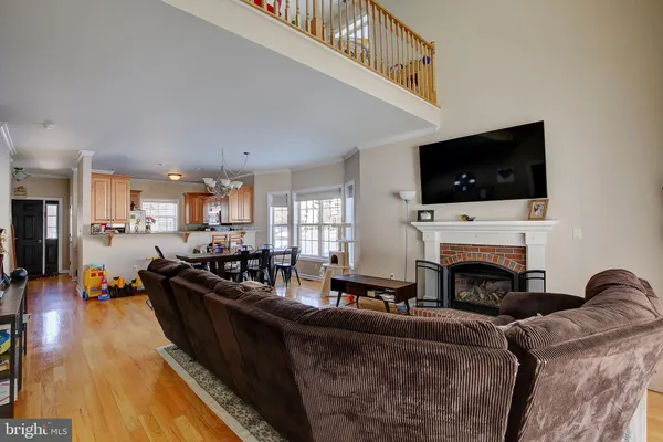 a living room with dining room and kitchen view
