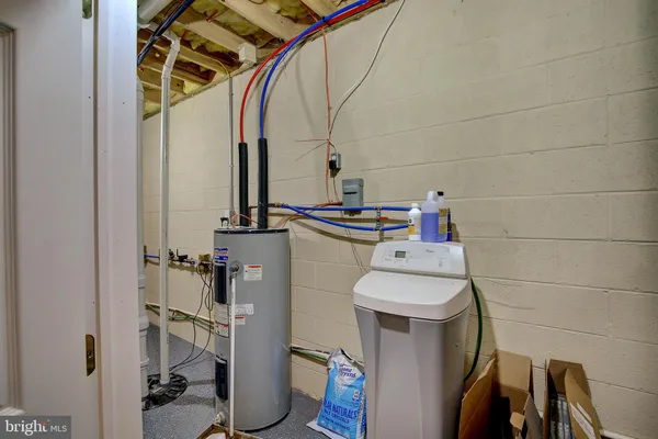 a bathroom with a washing machine and shower