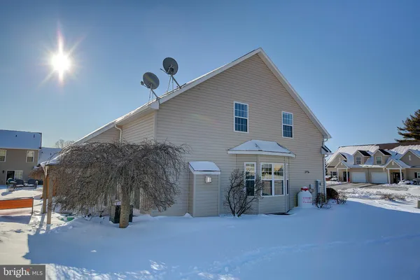 a view of a house with backyard and sitting area