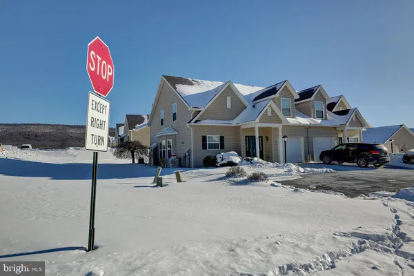 a kitchen with stainless steel appliances granite countertop a refrigerator sink and stove