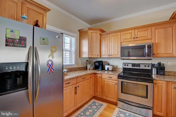a kitchen with stainless steel appliances granite countertop a sink stove and microwave