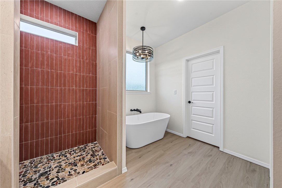 6138 New Hope Road Hackett, AR 72937 - Photo 33 of 56 Walk-in shower with vertical terracotta-toned tile and pebble flooring