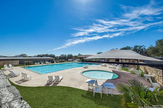 an aerial view of residential house with outdoor space and swimming pool
