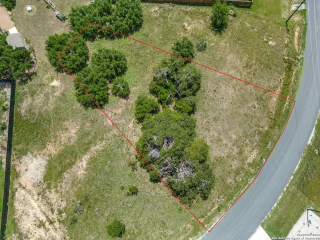 an aerial view of a golf course with a lake view