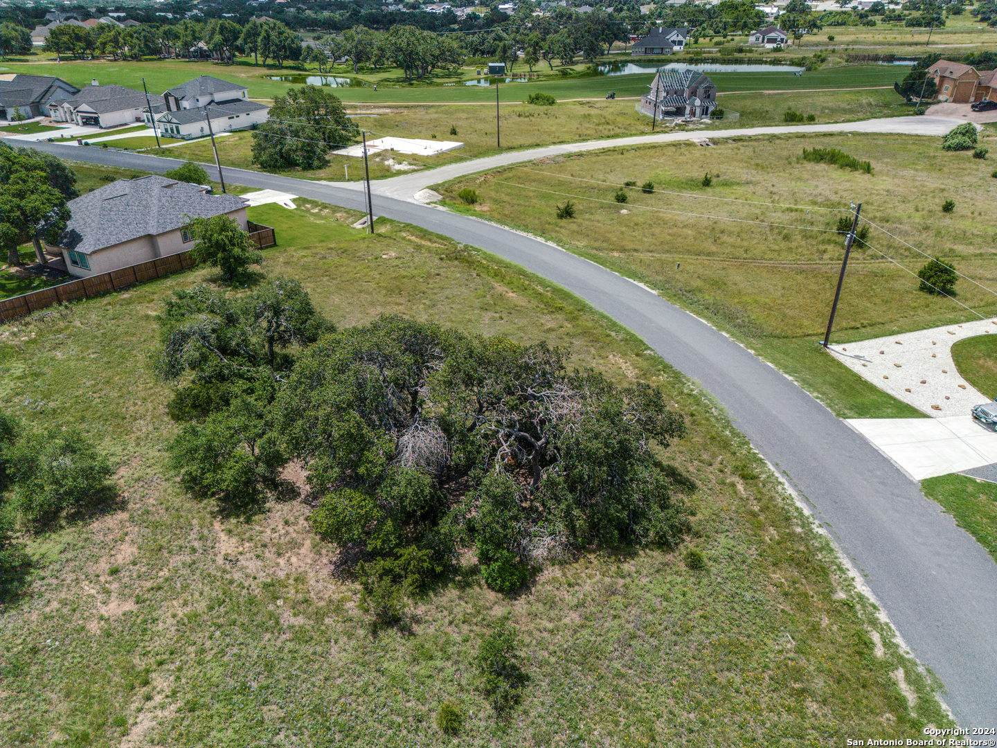 204 Hiram Cook Blanco, TX 78606 - Photo 4 of 15 an aerial view of a golf course with a lake view